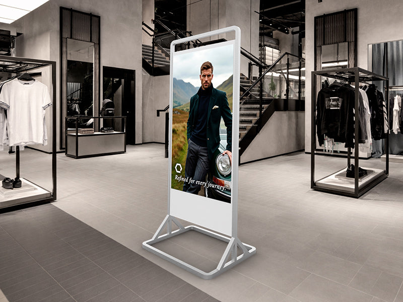 Digital display screen in a modern clothing store with a man in a suit on the screen.
