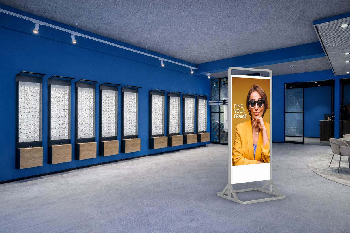 Modern eyewear store interior with digital display and mirror system.