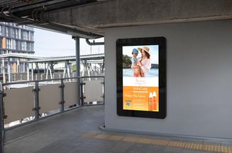 Digital display on a wall with an advertisement in an outdoor setting