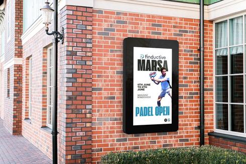 Digital display on a brick wall with promotional content for a padel event.
