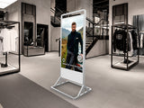 Digital display screen in a modern clothing store with a man in a suit on the screen.