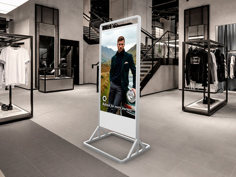 Digital display screen in a modern clothing store with a man in a suit on the screen.