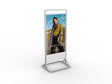 Portrait display stand with a person wearing a green jacket and scarf on a white background