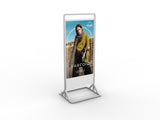 Portrait display stand with a person wearing a green jacket and scarf on a white background